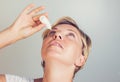 woman using eye drops in eyes Royalty Free Stock Photo