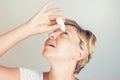 Woman using eye drops in eyes Royalty Free Stock Photo