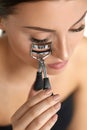 Woman Using Eyelash Curler For Curly Eyelashes. Beauty Makeup
