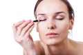 Woman using an eyeliner Royalty Free Stock Photo