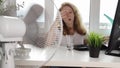 Woman using a fan to stay cool indoors, Preventing heatstroke, office worker in the heat at the workplace in the office