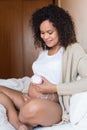 Woman using a fetal doppler at home