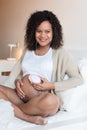 Woman using a fetal doppler at home