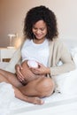 Woman using a fetal doppler at home Royalty Free Stock Photo