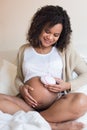 Woman using a fetal doppler at home