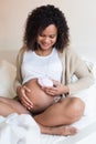 Woman using a fetal doppler at home Royalty Free Stock Photo