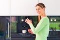 Woman using fully automatic coffee machine Royalty Free Stock Photo