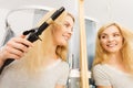 Woman using hair curler Royalty Free Stock Photo