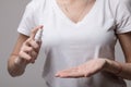 Woman using hand antibacterial spray. Girl wipes her hands with anti-bacterial sanitizer,desinfectant bottle. Coronavirus