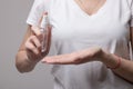 Woman using hand antibacterial spray. Girl wipes her hands with anti-bacterial sanitizer,desinfectant bottle. Coronavirus