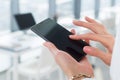 Woman using her digital device, reading news, sending sms, surfing internet, blogging and apps in office, close-up photo Royalty Free Stock Photo