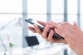 Woman using her digital device, reading news, sending sms, surfing internet, blogging and apps in office, close-up photo Royalty Free Stock Photo