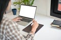 A woman using her laptop computer, working on her work in her office Royalty Free Stock Photo