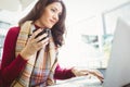 Woman using her laptop and drinking coffee Royalty Free Stock Photo