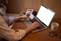 A woman using her laptop and holding her credit card, registering her credit card account on website Royalty Free Stock Photo