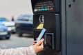 Woman using her mobile phone for payment for public parking by NFC. Contactless payment system with copy space. Royalty Free Stock Photo