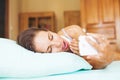 Woman using her phone as alarm clock Royalty Free Stock Photo