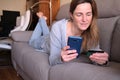 Woman is Using her Phone at Home for Shopping Online and Making a Payment Royalty Free Stock Photo