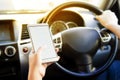 Woman using her smartphone open mobile application navigation or gps while driving. Blurred car interior background. Viewing Royalty Free Stock Photo