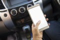 Woman using her smartphone open mobile application navigation or gps while driving. Blurred car interior background. Viewing Royalty Free Stock Photo