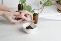 Woman using homemade coffee scrub for pilling, tasting on her hands before applying on face Royalty Free Stock Photo