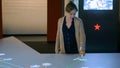 Woman using interactive touchscreen display