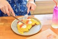 Woman Using Knife and Fork to Eat Scrambled Eggs on Toast Royalty Free Stock Photo