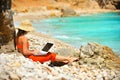 Woman using laptop on the beach Royalty Free Stock Photo