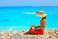 Woman using laptop on the beach Royalty Free Stock Photo