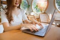 Woman using laptop in the cafe. Browsing Internet Data Information with blank search bar. SEO Networking Concept. Girl use Royalty Free Stock Photo