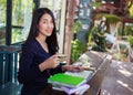 Woman using laptop at cafe while drinking coffee Royalty Free Stock Photo