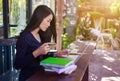 Woman using laptop at cafe while drinking coffee Royalty Free Stock Photo