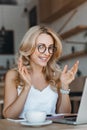 cheerful businesswoman in eyeglasses using laptop Royalty Free Stock Photo