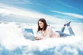Woman using Laptop on Cloud. Happy Young Girl typing on Computer Lying Down. Cloud Technology Internet Information Data Concept