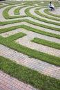 Woman Using Laptop in a Cobblestone Maze Royalty Free Stock Photo