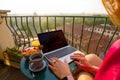 Woman using laptop computer on balcony Royalty Free Stock Photo
