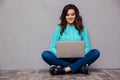 Woman using laptop computer on the floor