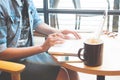 Woman using laptop computer and mobile phone on coffee table, On Royalty Free Stock Photo