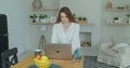 Woman using laptop computer. Portrait of business woman watching news at laptop screen and drinking coffee at home Royalty Free Stock Photo