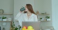 Woman using laptop computer. Portrait of business woman watching news at laptop screen and drinking coffee at home Royalty Free Stock Photo