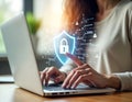 Woman using laptop with futuristic tech interface. Secure personal data protection concept. Finger scanning for access