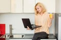 Woman using laptop in the kitchen Royalty Free Stock Photo