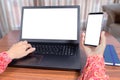 Woman Using laptop and mobile phone at home as teleworking concept Royalty Free Stock Photo