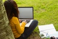 Woman using laptop in park