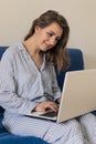 Woman using laptop personal computer on sofa. Work from home