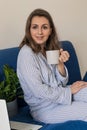 Woman using laptop personal computer on sofa. Work from home