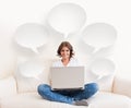 Woman using laptop and a phone on the sofa Royalty Free Stock Photo