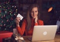 Woman using laptop, shopping online, using credit card at home. Royalty Free Stock Photo