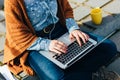 Woman using laptop while sitting on cement stairs Royalty Free Stock Photo