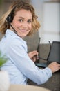 woman using laptop on sofa and wearing headset with miscophone Royalty Free Stock Photo